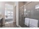 Elegant bathroom featuring glass enclosed shower with gray tile and view to the bright bedroom at 35658 N Lodestone Dr, San Tan Valley, AZ 85144