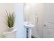 Powder room features pedestal sink, modern faucet, large mirror and tiled floor at 35658 N Lodestone Dr, San Tan Valley, AZ 85144