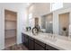 Bathroom featuring double sinks, quartz counters, modern dark cabinets, and a glass enclosed shower at 35658 N Lodestone Dr, San Tan Valley, AZ 85144