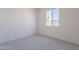 Bright bedroom featuring carpeted floors, neutral walls, and a large window at 35658 N Lodestone Dr, San Tan Valley, AZ 85144