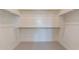 A spacious walk-in closet with shelving and carpet at 35658 N Lodestone Dr, San Tan Valley, AZ 85144