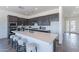 A modern kitchen featuring an island with a sink, and stainless steel appliances at 35658 N Lodestone Dr, San Tan Valley, AZ 85144