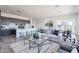 Open concept living space includes a sectional sofa and view of the kitchen at 35658 N Lodestone Dr, San Tan Valley, AZ 85144