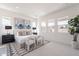 Spacious main bedroom with modern decor, including artwork and indoor plants, and plenty of natural light from several large windows at 35658 N Lodestone Dr, San Tan Valley, AZ 85144