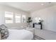 Bright main bedroom featuring modern decor, a sitting area, and large windows overlooking the landscaped yard at 35658 N Lodestone Dr, San Tan Valley, AZ 85144
