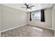 Bedroom featuring wood-look floors, modern ceiling fan, a window, and gray blackout curtains at 3624 W Citrus Way, Phoenix, AZ 85019