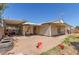 Backyard with brick paver patio, lawn, and home exterior with covered patios at 3727 W Gardenia Ave, Phoenix, AZ 85051