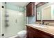 Bathroom featuring granite vanity with dark wood cabinets and a glass-enclosed shower at 3727 W Gardenia Ave, Phoenix, AZ 85051