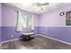 Purple bedroom with a window offering views of the outdoors, and a simple round table at 3727 W Gardenia Ave, Phoenix, AZ 85051