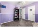 Purple bedroom featuring a bookshelf and a doorway, creating an inviting space at 3727 W Gardenia Ave, Phoenix, AZ 85051