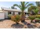 Charming home with rock landscaping, palm trees, flowering bushes, mature trees, and a decorative fountain in the front yard at 3727 W Gardenia Ave, Phoenix, AZ 85051
