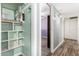 Hallway with wood floors and a built-in shelving unit, offering both style and functionality at 3727 W Gardenia Ave, Phoenix, AZ 85051