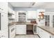 Airy kitchen showcases white cabinets, stone countertops, tile backsplash, and stainless-steel sink at 3727 W Gardenia Ave, Phoenix, AZ 85051
