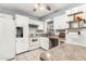 Bright kitchen boasts white cabinets, stone countertops, tile backsplash, and stainless-steel sink at 3727 W Gardenia Ave, Phoenix, AZ 85051