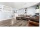 Comfortable living room with neutral-toned furnishings, wall decor, wood-look flooring, and an open floor plan at 3727 W Gardenia Ave, Phoenix, AZ 85051