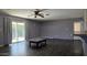 Bright living room with sliding glass doors, dark floors, and neutral paint at 3727 W Gardenia Ave, Phoenix, AZ 85051