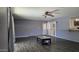 Bright living room with hardwood floors, french doors, and a breakfast bar cutout to the kitchen at 3727 W Gardenia Ave, Phoenix, AZ 85051