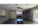 Spacious living room features dark hardwood floors, neutral paint, and a ceiling fan at 3727 W Gardenia Ave, Phoenix, AZ 85051