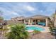 Spacious backyard oasis with a sparkling pool, covered patio, lush landscaping, and a privacy fence at 42711 N 43Rd Dr, New River, AZ 85087