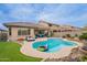 Backyard featuring a sparkling pool, covered patio, outdoor seating, and well-manicured landscaping at 42711 N 43Rd Dr, New River, AZ 85087