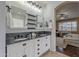 Beautiful bathroom featuring double sinks, a modern vanity, and an open view to the main bedroom at 42711 N 43Rd Dr, New River, AZ 85087