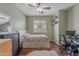 Bedroom featuring dark wood floors, a ceiling fan and a window at 42711 N 43Rd Dr, New River, AZ 85087