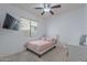 Cozy bedroom featuring a ceiling fan, window, and TV at 42711 N 43Rd Dr, New River, AZ 85087