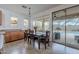 Dining area with sliding doors to the outdoor pool and backyard, ideal for enjoying indoor-outdoor living at 42711 N 43Rd Dr, New River, AZ 85087
