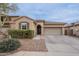 Charming single-Gathering home featuring a well-manicured lawn, two car garage, and a welcoming front entrance at 42711 N 43Rd Dr, New River, AZ 85087