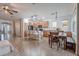 Open kitchen and dining area featuring wood cabinets, granite countertops, stainless appliances, and bar seating at 42711 N 43Rd Dr, New River, AZ 85087