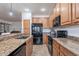 Stylish kitchen with granite countertops, stainless steel appliances, and ample cabinet space, offering modern functionality at 42711 N 43Rd Dr, New River, AZ 85087