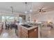 A modern kitchen with granite countertops, a large island with a sink, and an eat-in dining area at 42711 N 43Rd Dr, New River, AZ 85087