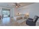 Comfortable living room with ample seating, soft lighting, and access to outdoor pool, ideal for relaxation and entertaining at 42711 N 43Rd Dr, New River, AZ 85087