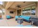 Inviting covered patio with comfortable seating, a ceiling fan, a built-in grill, and an outdoor TV at 42711 N 43Rd Dr, New River, AZ 85087