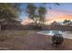 Spacious backyard with a pool, gravel landscaping, and a fire pit at 4325 E Vallejo Ct, Gilbert, AZ 85298