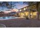 Outdoor entertaining space with pool, covered patio, and fire pit at 4325 E Vallejo Ct, Gilbert, AZ 85298