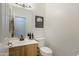 Bathroom featuring a white sink and toilet with neutral wall decor at 4325 E Vallejo Ct, Gilbert, AZ 85298