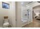 Bathroom featuring a glass enclosed shower, soaking tub and toilet at 4325 E Vallejo Ct, Gilbert, AZ 85298