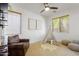 Cozy bedroom featuring a leather arm chair, teepee, plush rug, ceiling fan, and natural light at 4325 E Vallejo Ct, Gilbert, AZ 85298