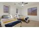 Bedroom featuring two twin beds, wood blinds, and neutral carpet at 4325 E Vallejo Ct, Gilbert, AZ 85298