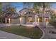 Charming two-story home showcasing lush green lawn, mature trees, and a welcoming entrance at 4325 E Vallejo Ct, Gilbert, AZ 85298