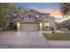 Inviting exterior showcasing a spacious driveway and well-maintained lawn, blending functionality with charm at 4325 E Vallejo Ct, Gilbert, AZ 85298