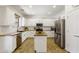 Well-lit kitchen boasts white cabinetry, stainless steel appliances and a center island with breakfast bar at 4325 E Vallejo Ct, Gilbert, AZ 85298