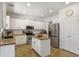 A spacious kitchen featuring white cabinets, stainless steel appliances, an island and granite counter tops at 4325 E Vallejo Ct, Gilbert, AZ 85298