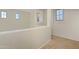 Upstairs landing area featuring neutral carpet and multiple windows providing natural light at 4325 E Vallejo Ct, Gilbert, AZ 85298