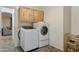 Laundry room with light wood cabinets and front load washer and dryer at 4325 E Vallejo Ct, Gilbert, AZ 85298