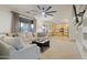 Open concept living room with a view of the kitchen, modern furniture and a ceiling fan at 4325 E Vallejo Ct, Gilbert, AZ 85298