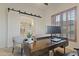 Office featuring a barn door, plantation shutters, desk, and comfortable seating at 4325 E Vallejo Ct, Gilbert, AZ 85298