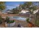 Inviting backyard pool area surrounded by mature trees and lush landscaping at 4325 E Vallejo Ct, Gilbert, AZ 85298