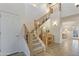 Elegant entryway showcases a wooden staircase with iron spindles and stylish decor at 4325 E Vallejo Ct, Gilbert, AZ 85298